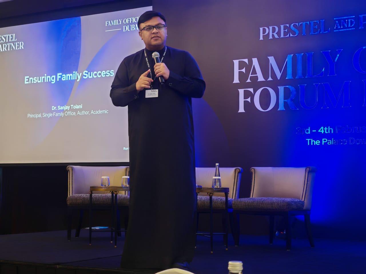 Dr. Sanjay Tolani speaking at a family-office forum in Dubai.
