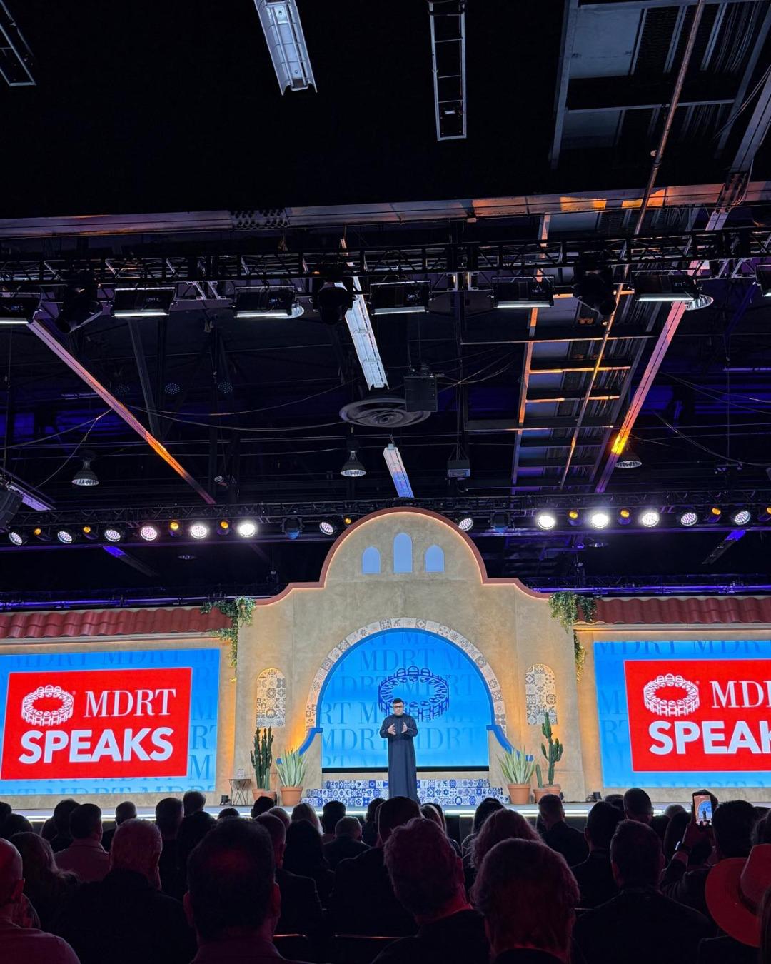 Dr. Sanjay Tolani speaking on the MDRT stage