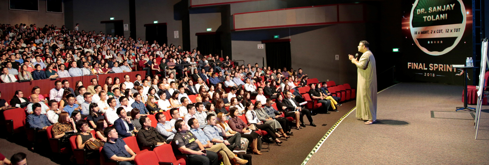 Dr. Sanjay Tolani speaking to a large international audience.